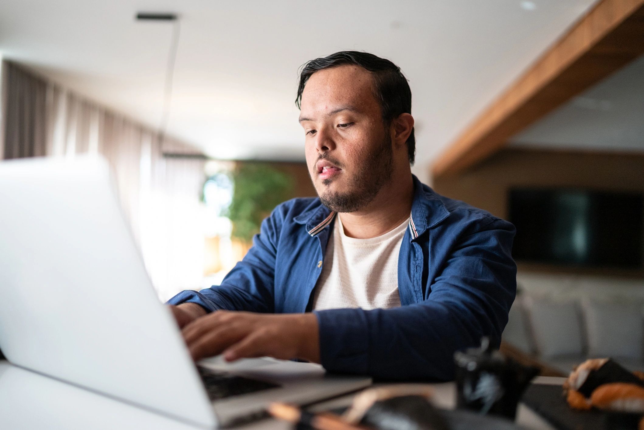 Person watching a livestream on a laptop at home