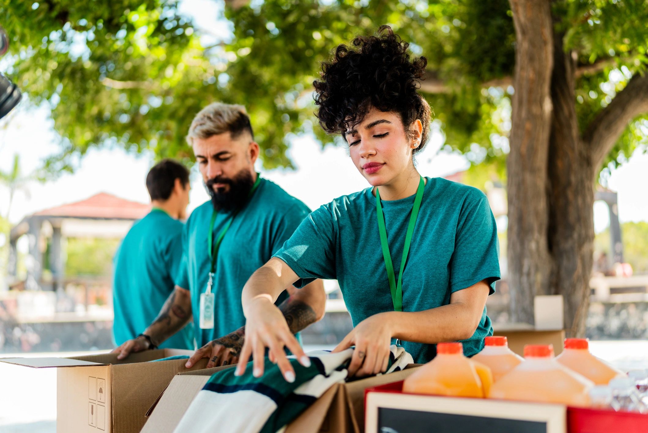 Volunteer organizing donation boxes outdoors