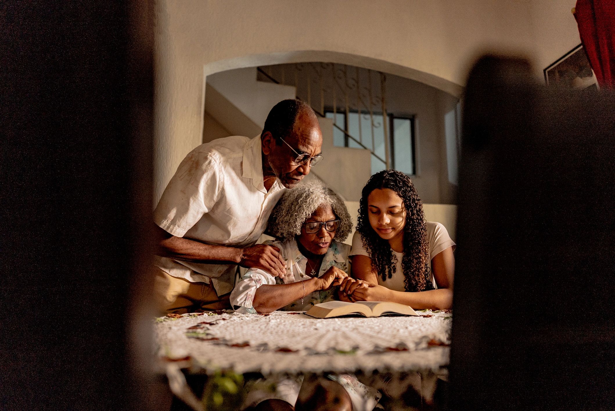 Family reading the Bible together at home